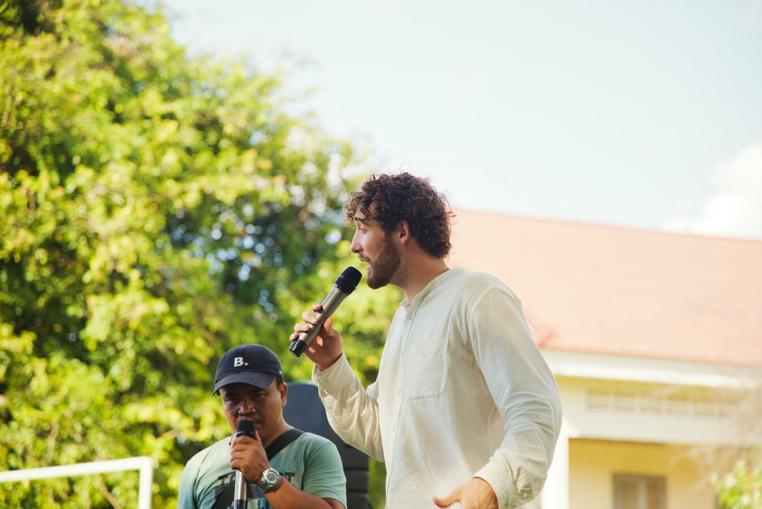 Chris preaching outdoors alongside an interpreter
