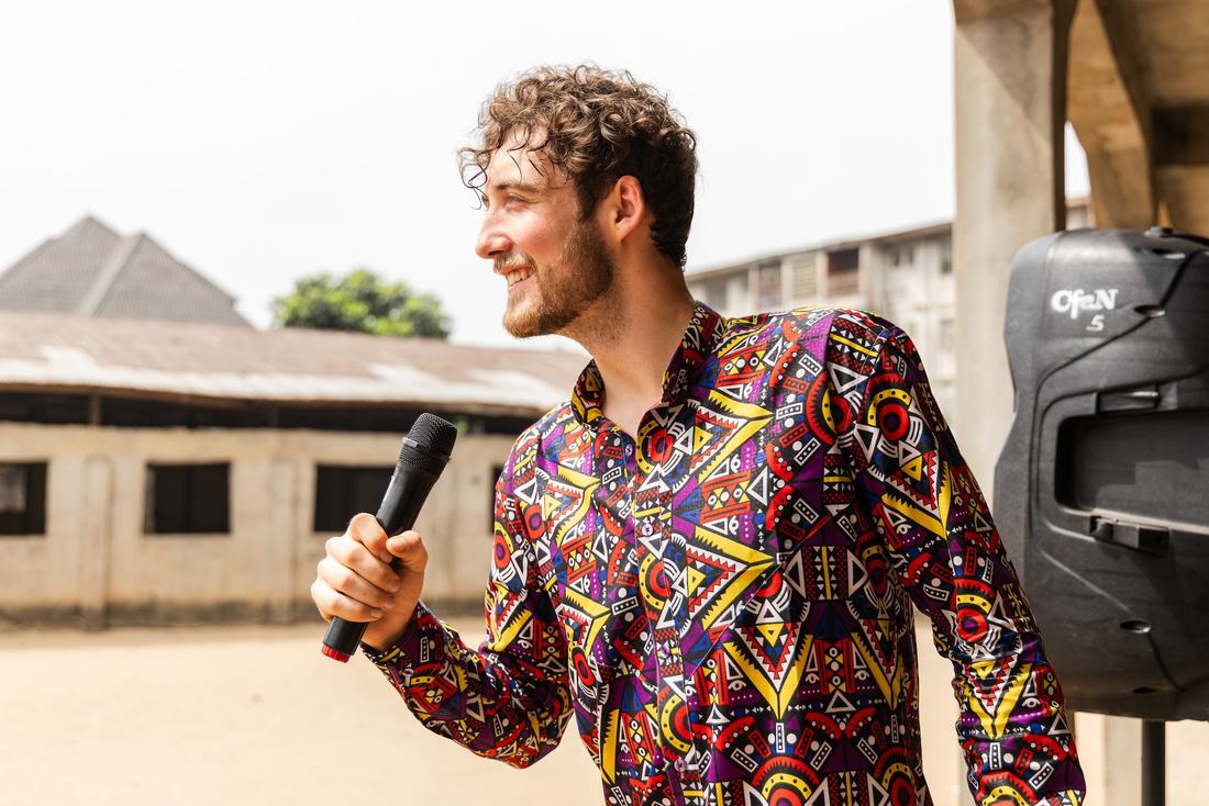Chris smiling as he preaches at an outdoor outreach