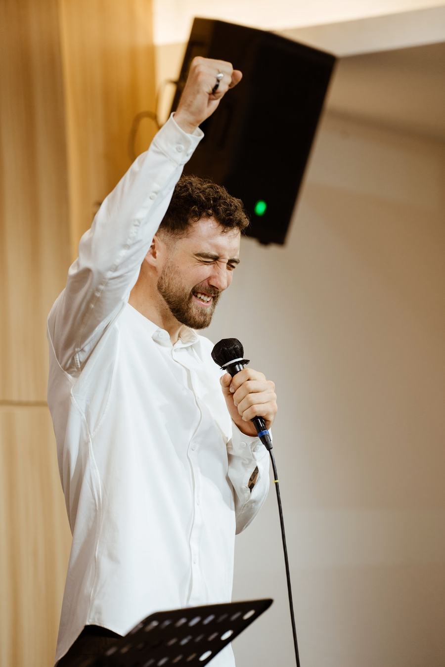 Chris Cashen preaching with his fist raised and a microphone in hand